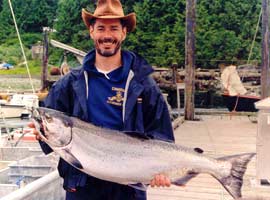 Fisherman with salmon on clayoquot wild charter